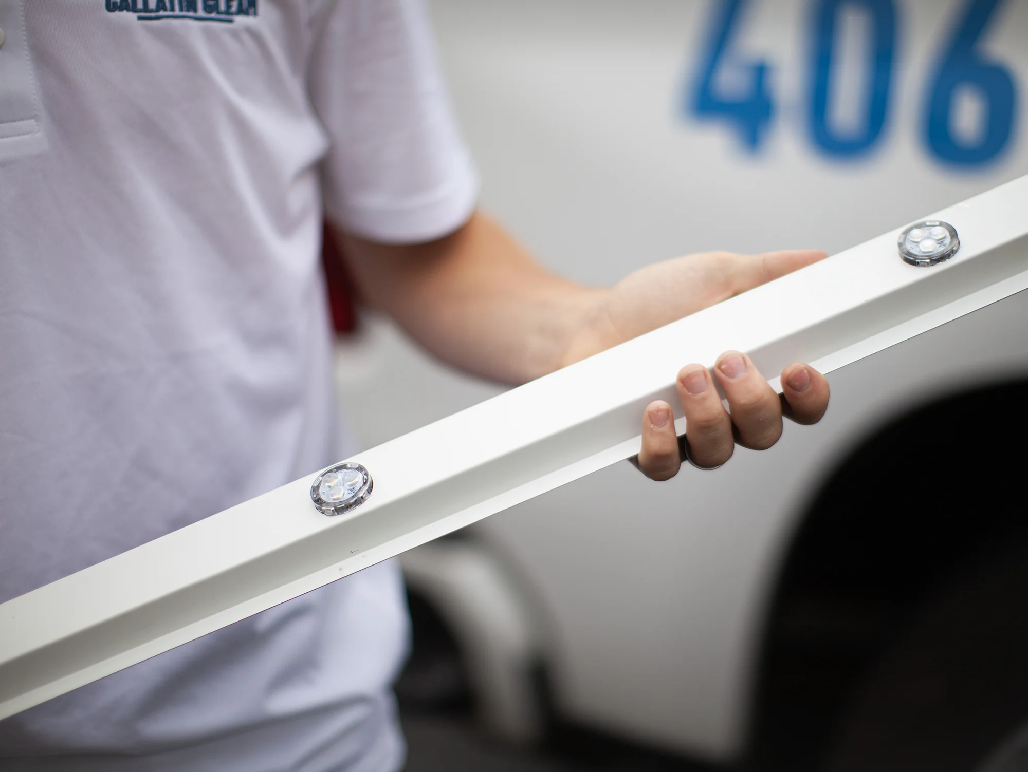 Gallatin Gleam employee holding a LED Gallatin Gleam employee holding a LED